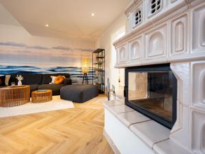 a living room with a fireplace and a couch at Villa Brunnenstraße, App 3 in Heringsdorf