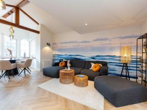 a living room with a couch and a table at Villa Brunnenstraße, App 3 in Heringsdorf +25 photos