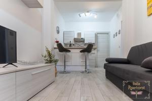 a living room with a couch and a bar at Italia Apartment in Catania