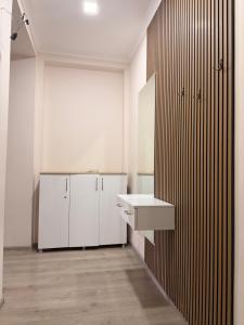 a kitchen with white cabinets and a sink at Amazing flat in the best location in Tsqaltubo