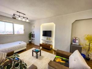 a large living room with a bed and a tv at luxurios hotel with pyramids view in Cairo
