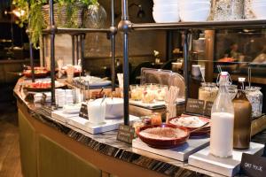 a buffet of food on a counter in a restaurant at AMO by AMANO Friedrichstrasse in Berlin +96 photos