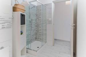 a shower with a glass door in a bathroom at Italia Apartment in Catania +14 photos