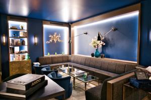 a living room with a couch and a table at AMO by AMANO Friedrichstrasse in Berlin