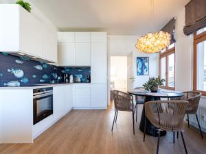 a kitchen and dining room with a table and chairs at Villa Linquenda App 6 in Ahlbeck