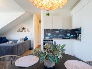 a kitchen and living room with a table and chairs at Villa Linquenda App 6 in Ahlbeck +14 photos