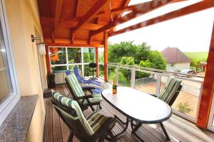 a patio with a table and chairs on a balcony at HAUS MUeRITZBRISE _ OG_Fewo in Klink
