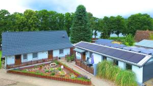 a model of a house with solar panels on it at FEWO Am Haussee Feldberger Seenlandschaft in Feldberg