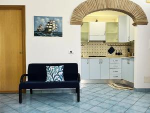 a living room with a couch and a kitchen at Casa Tasca in Ravello