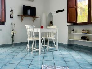 a kitchen with a white table and two chairs at Casa Tasca in Ravello