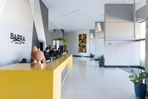 a lobby of a restaurant with people sitting at a counter at BHS Flat a beira mar 2203 in Recife +40 photos