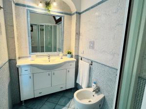 a bathroom with a sink and a mirror and a toilet at Casa Tasca in Ravello +6 photos