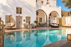 a swimming pool in the middle of a house at The Museum Project Oia in Oia