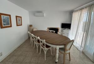 a dining room with a wooden table and chairs at Thelma house Tossa in Tossa de Mar