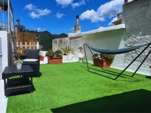 a hammock on a patio with green grass at Casa Tasca in Ravello