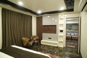 a hotel room with a bed and a waiting room at Shiv Resort & Palace in Shivpurī