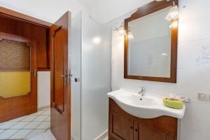 a bathroom with a sink and a mirror at Ulivello House Sea View in Massa Lubrense +22 photos
