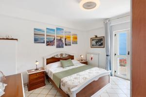 a bedroom with a bed and some paintings on the wall at Ulivello House Sea View in Massa Lubrense