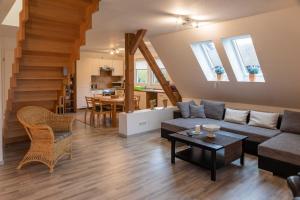 a living room with a couch and a table at FEWO Maisonettenwohnung in Steinkirchen +15 photos