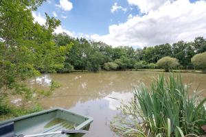 a boat sitting in the middle of a lake at Gite Douceur de vivre in Saint-Avaugourd-des-Landes +74 photos