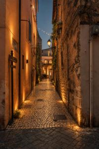 an alleyway with a street light in a city at night at Vicolo delle Belle Suite in Terracina