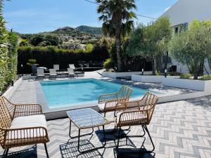 a patio with chairs and a swimming pool at Residence Villa Branda in Calvi