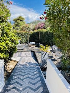 a garden with chairs and a walkway at Residence Villa Branda in Calvi