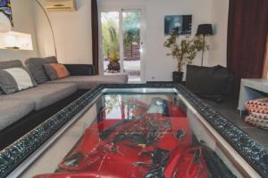 a glass table in a living room with a red object at Residence Villa Branda in Calvi +68 photos