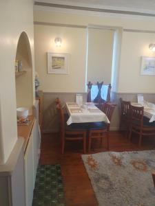 a dining room with a table and some chairs at Smugglers Rest in Newquay