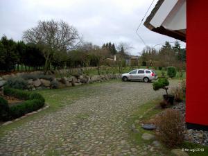 a car parked in the driveway of a house at Landhaus Uhlenhof 4 in Groß Zicker