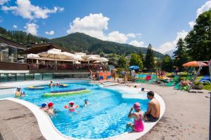 a group of people in a pool at a resort at Garni Toni in Ortisei