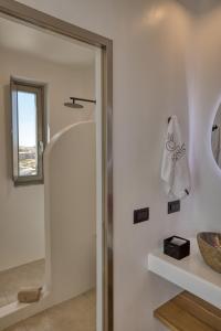 a bathroom with a shower and a sink at Ionic Suites in Super Paradise Beach