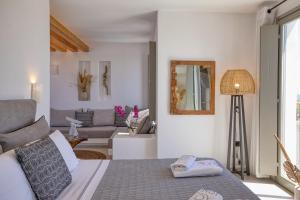 a bedroom with a bed and a living room at Ionic Suites in Super Paradise Beach