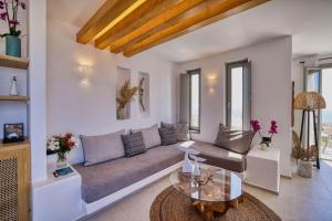 a living room with a couch and a table at Ionic Suites in Super Paradise Beach