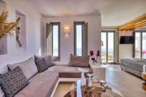 a living room with a couch and a table at Ionic Suites in Super Paradise Beach