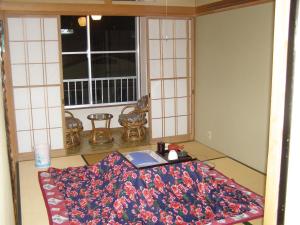 a table with a blanket on the floor in a room at Kadowakikan in Nozawa Onsen