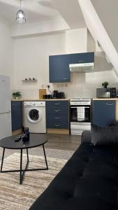 a living room with a couch and a table at Sheffield city centre apartment in Midland