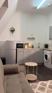 a living room with a couch and a kitchen at Sheffield city centre apartment in Midland +52 photos