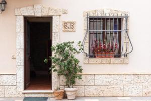 a building with a window with flowers in it at Bed and Breakfast San Domenico in Realmonte