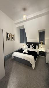 a bedroom with a large bed and two tables and two lamps at Sheffield city centre apartment in Midland