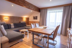 a living room with a couch and a table at Altroiterhof in St. Wolfgang