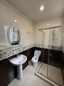 a bathroom with a toilet and a sink and a shower at Deluxe Family Stay Near The Beach in Kvariati +37 photos