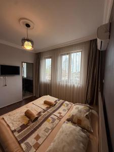 a bedroom with a large bed with two pillows on it at Deluxe Family Stay Near The Beach in Kvariati