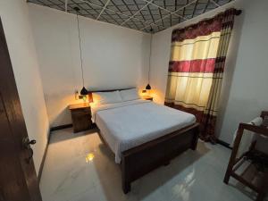 a bedroom with a bed and a window at Mulberry Villa in Anuradhapura +28 photos