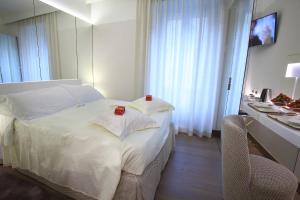 a bedroom with a bed with two red candles on it at Hotel Berna in Milan