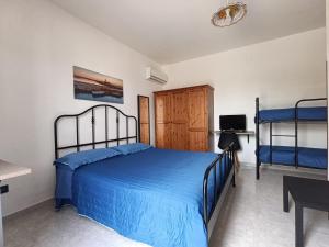 a bedroom with a bed and two bunk beds at Villa Maria in Campobello di Mazara