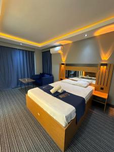 a hotel room with a large bed and a table at tuzla first house in Tuzla