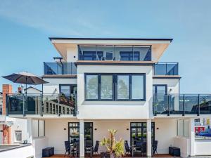a large white house with a balcony at Fewo`s Mehlberg Binz in Binz +60 photos
