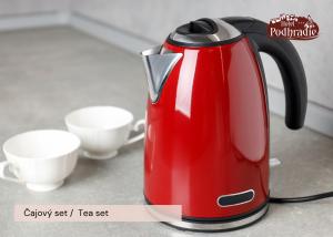 a red tea kettle is sitting on a counter at Hotel Podhradie in Považská Bystrica