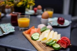 a cutting board with fruits and vegetables on a table at Siegelsbacher Muehle in Siegelsbach